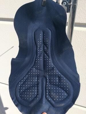 Dark blue cycling chamois with perforated padding for ventilation, displayed against a neutral background