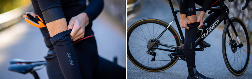 Cyclist adjusting Santini arm and leg warmers during a ride on a road bike.