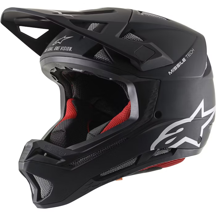 Black full-face helmet with red interior padding, featuring a visor and ventilation openings.