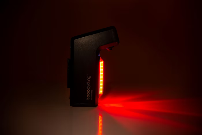 A red bike rear light illuminating in a dark environment.