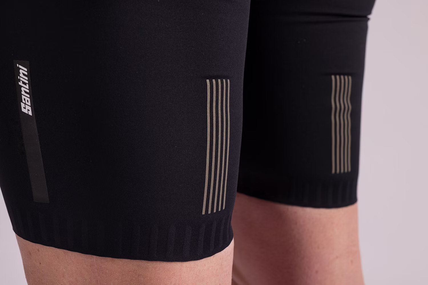 Close-up view of Santini cycling shorts with reflective stripe detailing.
