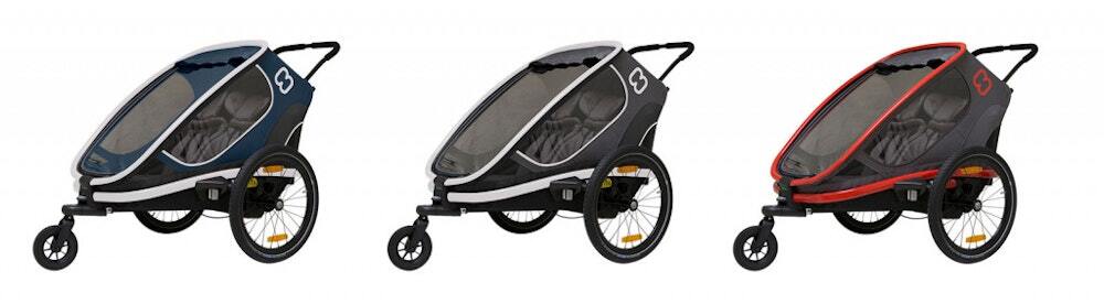 Three child bike trailers in different colors