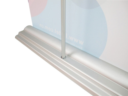 Detailed view of the premium roll up banner stand base with a graphics banner securely installed into the aluminum frame.