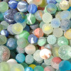 Most sea glass marbles are catseye marbles. They were machine made and widely used as children's toys for generations. Marbles were also used as ballast on ships and to mixed spray paint in cans.