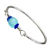 An electric aqua recycled glass bead is sandwiched between blue sea glass pieces in this sterling bangle bracelet!
