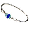 Tropical aqua sea glass combined with a cobalt blue bead on our best solid sterling bangle bracelet.