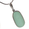 The remnant of a bottle stopped in seafoam green sea glass is expertly set in our Original Wire Bezel© necklace pendant setting.