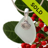 Beach found seafoam green sea glass is combined with a solid sterling shell charm and presented on an 18 Inch solid sterling snake chain.