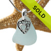 A perfect piece of natural pale aqua blue sea glass set on a solid sterling hand cast bail with a sterling silver heart i hearts charm. A perfect sea glass necklace for any sea glass lover!