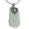 A large piece of natural seafoam green sea glass set on a solid sterling hand cast bail with a sterling silver heart in hearts charm. A perfect sea glass necklace for any sea glass lover!