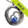 Blue sea glass pieces combined a large silver heart in this sea glass locket necklace.