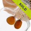 Vivid amber brown sea glass pieces set in our Original Wire Bezel© setting in gold with beach found sea glass from Puerto Rico to make a beautiful pair of genuine sea glass earrings.