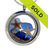 Blue sea glass pieces combined with a real starfish and beach sand in this sea glass locket necklace.