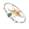 A thick piece of deep seafoam green sea glass combined with genuine fresh water pearls on a solid sterling bangle bracelet.