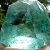 This thick round piece of aqua blue sea glass started out like the glass pictured here. This is end of day or slag glass. In the Seaham sea glass case, the chunks were discarded into the sea and now wash up on local beaches. This is why the sea glass from this area tends to be very round, thick and perfectly frosted.