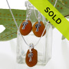 Warm amber brown sea glass in a silver set of earring and matching pendant with silver palm trees.
Sorry this sea glass jewelry item has been sold!