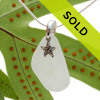 A white piece of TOP QUALITY sea glass set on a solid sterling bail with a sterling sea star charm.