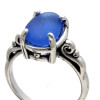 A perfect piece of blue beach found sea glass set in a solid sterling silver scroll ring.
