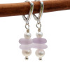 A stunning pair of sea glass earrings with light and darker purple sea glass and pearls.