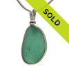 A glowing perfect piece of beach found glass from Seaham England in a stunning deep aqua green is set in our Original Wire Bezel© pendant setting.
Sorry this sea glass jewelry piece has already been sold!