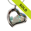 Small bits of tropical aqua sea glass pieces combined with real pearls and a sandollar in a feminine heart shaped locket magnetic stainless steel locket necklace! 