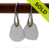 A pair of natural beach found sea glass earrings in a winter white on sterling silver deco hooks.
Sorry this sea glass jewelry selection has been sold!