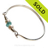 A stunning piece of vivid aqua sea glass combined with genuine fresh water pearls on a solid sterling bangle bracelet.
Sorry this Sea Glass Bracelet has been SOLD!
