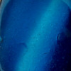 A detail of this mixed blue and aqua sea glass pendant reveals the telltale "C"'s that are indicative of Genuine Unaltered beach found sea glass.