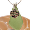 A very nice piece of peridot green sea glass necklace with a solid sterling silver mom charm.