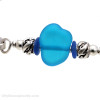 A detail of the vivid aqua blue handmade bead, sea life sterling beads and bright blue sea glass pieces.