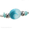 A detail of the bracelet shows the beauty of this handmade bead, the details of the sterling sea life beads and the vivid aqua sea glass.