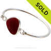 Genuine Sea Glass Bangle Bracelet in a P-E-R-F-E-C-T Ruby Red set in our Deluxe Wire Bezel© sterling silver setting.
SOLD - Sorry this Sea Glass Jewelry selection is NO LONGER AVAILABLE!