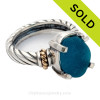 An Ultra Rare rare piece of Bright Electric Teal Blue Genuine Sea Glass Ring in a Sterling setting highlighted with 14k gold accents.
Sorry this Sea Glass Jewelry piece has been SOLD!