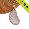 A top quality vivid purple or lavender sea glass from Maine in our Original Wire Bezel Pendant Setting© that leaves the sea glass UNALTERED from the way it was found on the beach. 
Sorry this Sea Glass Jewelry piece has been SOLD!