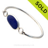 Genuine Sea Glass Bangle Bracelet in a P-E-R-F-E-C-T Vivid Thick Deep Blue glass set in our Deluxe Wire Bezel© sterling silver setting.
Sorry this Sea Glass Bracelet is NO LONGER AVAILABLE!