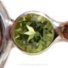 A genuine brilliant cut peridot 6MM gem is set in a "tube bezel" setting.