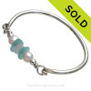 VIVID Aqua and Pure White Genuine Sea Glass Bangle Bracelet set with a Genuine Fresh Water TOP QUALITY Pearls and finished in sterling details on a Solid Sterling Round Bangle Bracelet.
SOLD - Sorry this Sea Glass Bangle Bracelet is NO LONGER AVAILABLE!