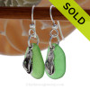 A simple pair of green Genuine Sea Glass Earrings with sterling lbeachy Flip Flop charms in a lightweight simple setting.