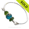 Bright Seaweed Green Genuine Sea Glass Bangle Bracelet set with a handmade lampwork glass wave bead set with sterling details on a solid sterling round bangle bracelet.
SOLD - Sorry this Sea Glass Bangle Bracelet is NO LONGER AVAILABLE!