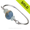 Genuine Seafoam Green Sea Glass Bangle Bracelet set with a handmade lamp work glass wave bead in blue with sterling end beads on a solid sterling full round premium bangle bracelet.
SOLD - Sorry this Sea Glass Bangle Bracelet is NO LONGER AVAILABLE!