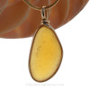 This beautiful Bright Vivid Electric Golden Seaham Sea Glass Pendant is set in our Original Wire Bezel© pendant setting in a 14K Rolled Gold.