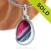 A vivid mix of hot pink and subtle blue and teal with streaks  of purple in this in a base of pure white endoday sea glass from England set in our Original Wire Bezel© necklace pendant setting.
SOLD - Sorry this Sea Glass Jewelry Selection is NO LONGER AVAILABLE!