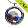 Cobalt Blue Sea Glass in a crystal and stainless steel locket combined with a two baby starfish and vivid White Crystal Gem. Finished with real beach sand for your personal beach on the go!