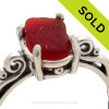 A stunning and lovely piece of bright Rare Ruby Red NATURAL beach found sea glass securely set in a solid sterling silver scroll ring. 
Ruby red glass is made mostly by the Anchor Hocking Company and was used widely in the mid 20th century in products like Schlitz Beer (show here), Avon products and houseware items.
SOLD - Sorry this Sea Glass Jewelry selection is NO LONGER AVAILABLE!