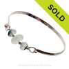 A Stunning Aqua and English Multi Sea Glass combined with real cultured pearls on this Solid Sterling Silver Half Round Sea Glass Bangle Bracelet.
