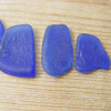 Examples of embossed blue sea glass from Milk Of Magnesia Bottles
