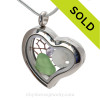 Simple and lovely green beach found Sea Glass combined a silver Heart Locket necklace with Sandollar , vintage seafan bit and a diamond like Crystal Gem.