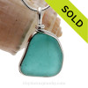 This is a beautiful Vivid Blue Aqua Sea Glass set in our Original Wire Bezel© pendant setting in Sterling Silver .