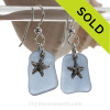 A pair of Natural Beach Found  Carolina Blue Sea Glass Earrings with Solid Sterling Starfish Charms.