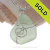 A small perfect piece of seafoam green sea glass is set in our popular Sea Swirl setting in sterling silver.